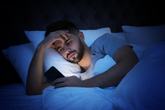 Using a computer or phone while in bed