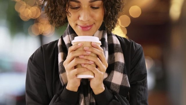 focus on the present A close-up of a person holding a warm coffee cup, focusing on the present moment to reduce stress.