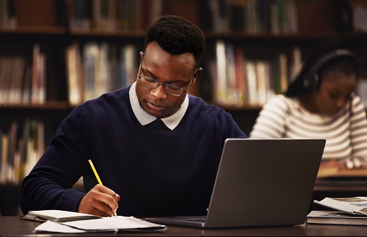 reviewing past decisions Person reviewing past decisions and writing reflections to learn and grow from mistakes